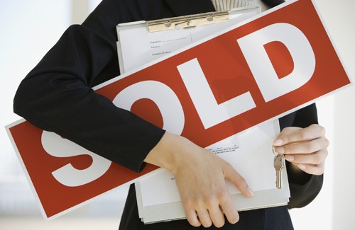 sell a home or condo with us sold sign