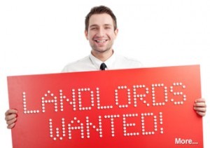 man with sign landlords wanted