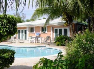 pink single family home with pool