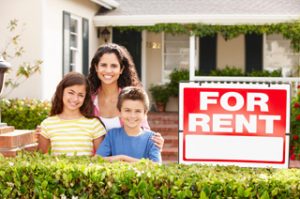 Mom with 2 kids next to For Rent sign