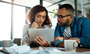 how much do i need to buy a home, couple looking at tablet