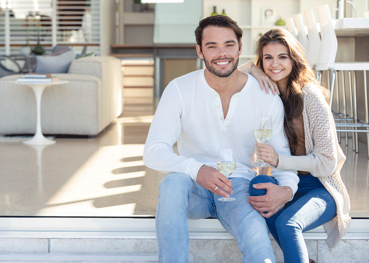 buy a home or condo with us couple drinking champagne